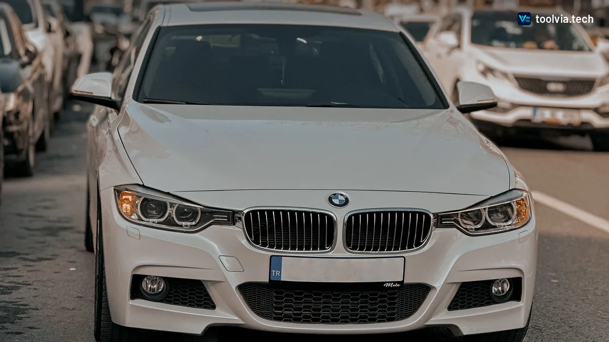 White BMW 3 Series sedan front view on a city street