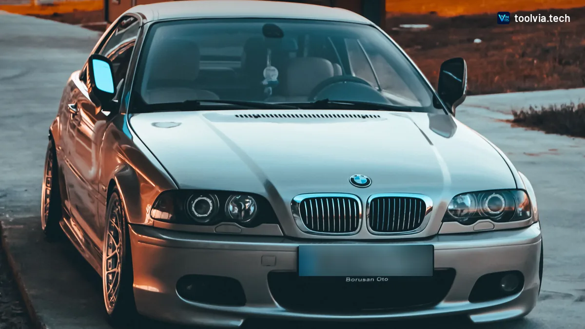 Silver BMW E46 3 Series coupe parked at sunset